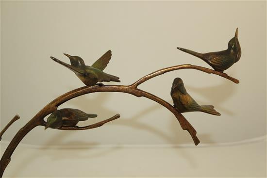 A 1920s French patinated bronze group of four birds upon a branch, L.14in.